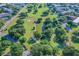 Aerial view of a golf course with lush greenery and surrounding residential area at 2231 Utopian E Dr # 117, Clearwater, FL 33763