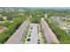 Aerial view of community buildings with ample parking and lush greenery at 2231 Utopian E Dr # 117, Clearwater, FL 33763