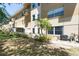 Building exterior with manicured backyard and covered patio, great for outdoor activities at 2231 Utopian E Dr # 117, Clearwater, FL 33763