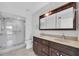 Modern bathroom featuring dual sinks, a glass shower, and a large vanity at 2231 Utopian E Dr # 117, Clearwater, FL 33763