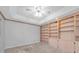 Spacious bedroom with tray ceilings, neutral paint, plush carpeting, and custom built-in shelving at 2231 Utopian E Dr # 117, Clearwater, FL 33763