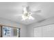 Bright ceiling fan in a bedroom, next to a window and a closet at 2231 Utopian E Dr # 117, Clearwater, FL 33763
