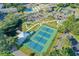 Aerial view of a community with tennis courts, swimming pool, pond, and landscaped grounds at 2231 Utopian E Dr # 117, Clearwater, FL 33763