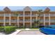 Exterior view of the condominium community, featuring multiple stories and private balconies at 2231 Utopian E Dr # 117, Clearwater, FL 33763