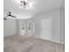 Spacious living room featuring neutral paint, plush carpeting, and bay windows with natural light at 2231 Utopian E Dr # 117, Clearwater, FL 33763