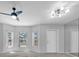 Bright living room with neutral paint, plush carpeting, and natural light from bay windows at 2231 Utopian E Dr # 117, Clearwater, FL 33763