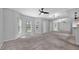 Open living room featuring neutral paint, plush carpeting, and bay windows with natural light at 2231 Utopian E Dr # 117, Clearwater, FL 33763
