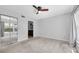 Spacious main bedroom with neutral carpet, closet, and ceiling fan at 2231 Utopian E Dr # 117, Clearwater, FL 33763