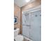 Bathroom featuring toilet and glass-enclosed shower with decorative wall accents at 2506 Laurelwood Dr # 4C, Clearwater, FL 33763