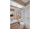 Bright bathroom with a skylight and a shower/tub combo with tile surround at 2506 Laurelwood Dr # 4C, Clearwater, FL 33763