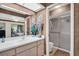 Ensuite bathroom with vanity, mirror, and walk-in shower with sliding glass doors at 2506 Laurelwood Dr # 4C, Clearwater, FL 33763