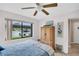 Sunlit bedroom features a ceiling fan, large window, and neutral walls at 2506 Laurelwood Dr # 4C, Clearwater, FL 33763