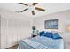 Bright bedroom with large closet, ceiling fan, and a cozy, beach-themed decor at 2506 Laurelwood Dr # 4C, Clearwater, FL 33763