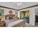 Cozy bedroom with slider door to porch featuring a ceiling fan and natural light at 2506 Laurelwood Dr # 4C, Clearwater, FL 33763