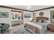 Bedroom featuring ensuite bath, ceiling fan, tile floors, and slider to porch at 2506 Laurelwood Dr # 4C, Clearwater, FL 33763