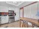 Cozy kitchen with stainless steel appliances, white cabinets, and adjacent wooden kitchen island at 2506 Laurelwood Dr # 4C, Clearwater, FL 33763