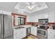 Bright kitchen with stainless steel appliances, white cabinetry, and double sink at 2506 Laurelwood Dr # 4C, Clearwater, FL 33763