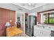 Bright kitchen featuring stainless steel refrigerator and double sink under the window overlooking foliage at 2506 Laurelwood Dr # 4C, Clearwater, FL 33763