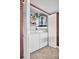 Functional laundry area with a full size washer and dryer, and storage shelving at 2506 Laurelwood Dr # 4C, Clearwater, FL 33763