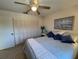 Cozy main bedroom featuring a ceiling fan, closet, and a beach-themed painting at 2506 Laurelwood Dr # 4C, Clearwater, FL 33763