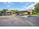 Exterior of condo featuring assigned carport parking and guest parking spaces on a sunny day at 2506 Laurelwood Dr # 4C, Clearwater, FL 33763