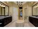 A luxury bathroom featuring dual sinks, vanity with seating, and decorative chandelier at 2680 Keystone Springs Rd, Tarpon Springs, FL 34688