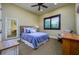 Cozy bedroom with plantation shutters, mirror, and comfortable sitting area at 2680 Keystone Springs Rd, Tarpon Springs, FL 34688