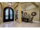 Lovely dining room with travertine floors and an elegant chandelier at 2680 Keystone Springs Rd, Tarpon Springs, FL 34688