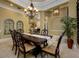 Elegant dining room with coffered ceiling, chandelier, and view to fireplace at 2680 Keystone Springs Rd, Tarpon Springs, FL 34688
