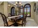 Elegant dining room with dark wood furnishings and large windows with shutters at 2680 Keystone Springs Rd, Tarpon Springs, FL 34688
