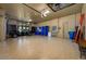 Expansive garage space features durable epoxy flooring, ample storage, and convenient garage door access at 2680 Keystone Springs Rd, Tarpon Springs, FL 34688