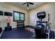 Home gym with workout equipment, mirrored wall, and ample floor space at 2680 Keystone Springs Rd, Tarpon Springs, FL 34688