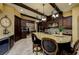 A spacious kitchen with a large granite island, stainless steel appliances, and dark wood cabinetry at 2680 Keystone Springs Rd, Tarpon Springs, FL 34688