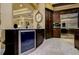 The kitchen boasts stainless steel appliances, dark cabinets, and a beverage refrigerator, showcasing modern convenience at 2680 Keystone Springs Rd, Tarpon Springs, FL 34688