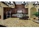 A granite countertop island features lighting and tile backsplash, complementing stainless steel appliances at 2680 Keystone Springs Rd, Tarpon Springs, FL 34688