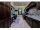Spacious laundry room features modern appliances, granite counters and built-in desk space at 2680 Keystone Springs Rd, Tarpon Springs, FL 34688