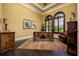 Home office with hardwood floors, natural light, and elegant wooden desk at 2680 Keystone Springs Rd, Tarpon Springs, FL 34688