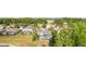 Real estate showcasing a home with screened pool and lush surroundings in a residential neighborhood at 27338 Hollybrook Trl, Wesley Chapel, FL 33544