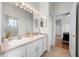 Bathroom featuring double sinks, white cabinets, and tile floors with a view to bedroom at 27338 Hollybrook Trl, Wesley Chapel, FL 33544