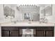 Bathroom featuring dual sinks, a large mirror and vanity lighting at 27338 Hollybrook Trl, Wesley Chapel, FL 33544