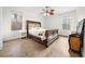 Cozy bedroom with wood flooring, ceiling fan, and ample natural light at 27338 Hollybrook Trl, Wesley Chapel, FL 33544
