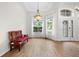 Inviting entryway with wood-look flooring, decorative lighting, and a stylish bench at 27338 Hollybrook Trl, Wesley Chapel, FL 33544