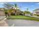 Beautiful single-Gathering home features mature landscaping and a well-manicured lawn at 27338 Hollybrook Trl, Wesley Chapel, FL 33544