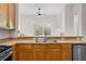 Well-lit kitchen featuring wood cabinets, stainless steel appliances, and a double basin sink at 27338 Hollybrook Trl, Wesley Chapel, FL 33544