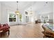 Spacious open-concept living area with elegant lighting and an abundance of natural light at 27338 Hollybrook Trl, Wesley Chapel, FL 33544