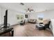 Spacious living area with wicker seating, wood-look flooring, and bright natural light at 27338 Hollybrook Trl, Wesley Chapel, FL 33544