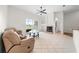Cozy living room with a fireplace, ceiling fan, and large glass sliding door at 27338 Hollybrook Trl, Wesley Chapel, FL 33544