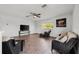 Bright living room with wood floors, ceiling fan, and comfortable wicker sofas at 27338 Hollybrook Trl, Wesley Chapel, FL 33544