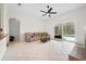Inviting living room featuring tile flooring, a ceiling fan, and access to the screened lanai at 27338 Hollybrook Trl, Wesley Chapel, FL 33544