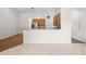 Open living space with a partial kitchen view, featuring ample natural light and tiled floors at 27338 Hollybrook Trl, Wesley Chapel, FL 33544